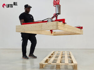LiftsAll vacuum gripper system lifting a wooden frame in a warehouse environment